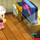A Pokemon trainer sits in her room looking at a TV.